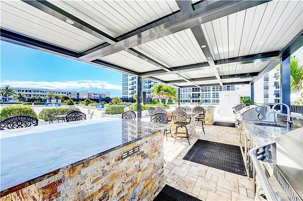 531 North Ocean Boulevard, Unit 506 Pompano Beach, FL 33062 - Photo 28 of 47 a view of a swimming pool with outdoor seating