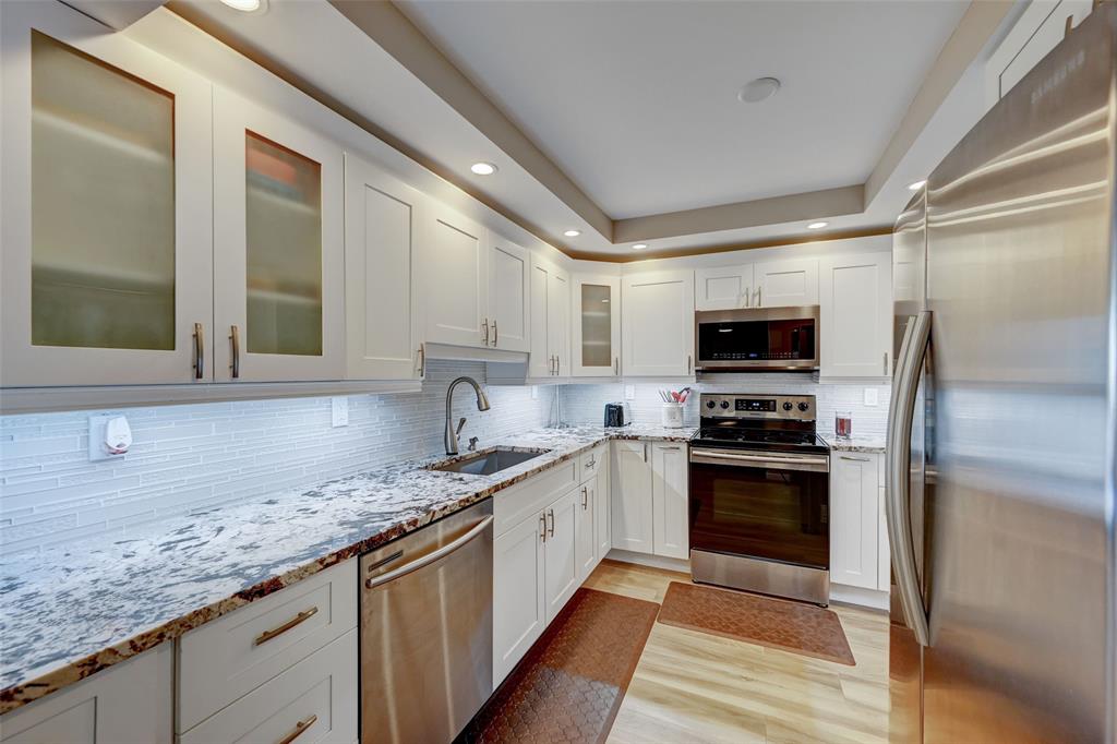 531 North Ocean Boulevard, Unit 506 Pompano Beach, FL 33062 - Photo 3 of 47 a kitchen with stainless steel appliances granite countertop a sink stove and refrigerator