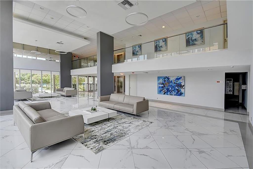 531 North Ocean Boulevard, Unit 506 Pompano Beach, FL 33062 - Photo 31 of 47 a living room with furniture and a large window