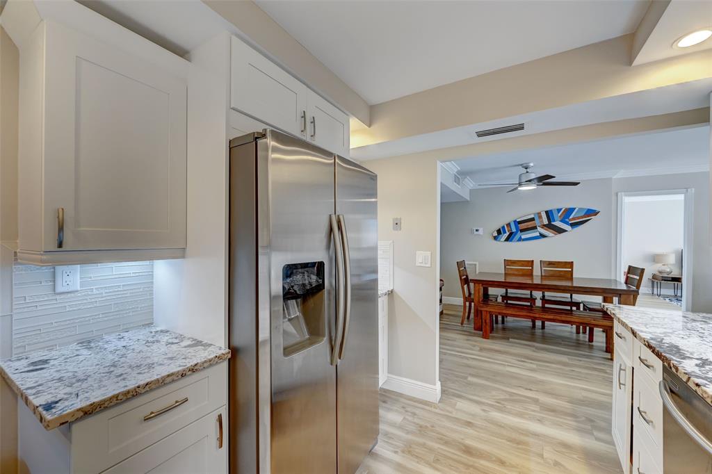 531 North Ocean Boulevard, Unit 506 Pompano Beach, FL 33062 - Photo 4 of 47 a kitchen with stainless steel appliances granite countertop a refrigerator and a stove top oven
