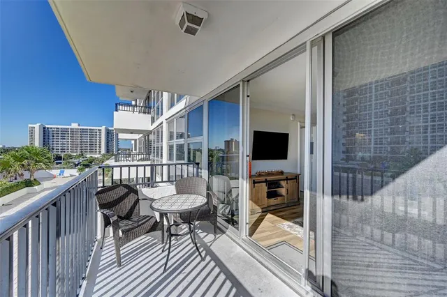 a balcony with furniture and a potted plant