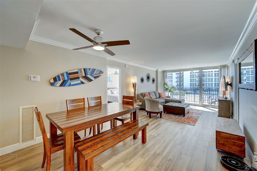 531 North Ocean Boulevard, Unit 506 Pompano Beach, FL 33062 - Photo 7 of 47 a living room with furniture and a wooden floor