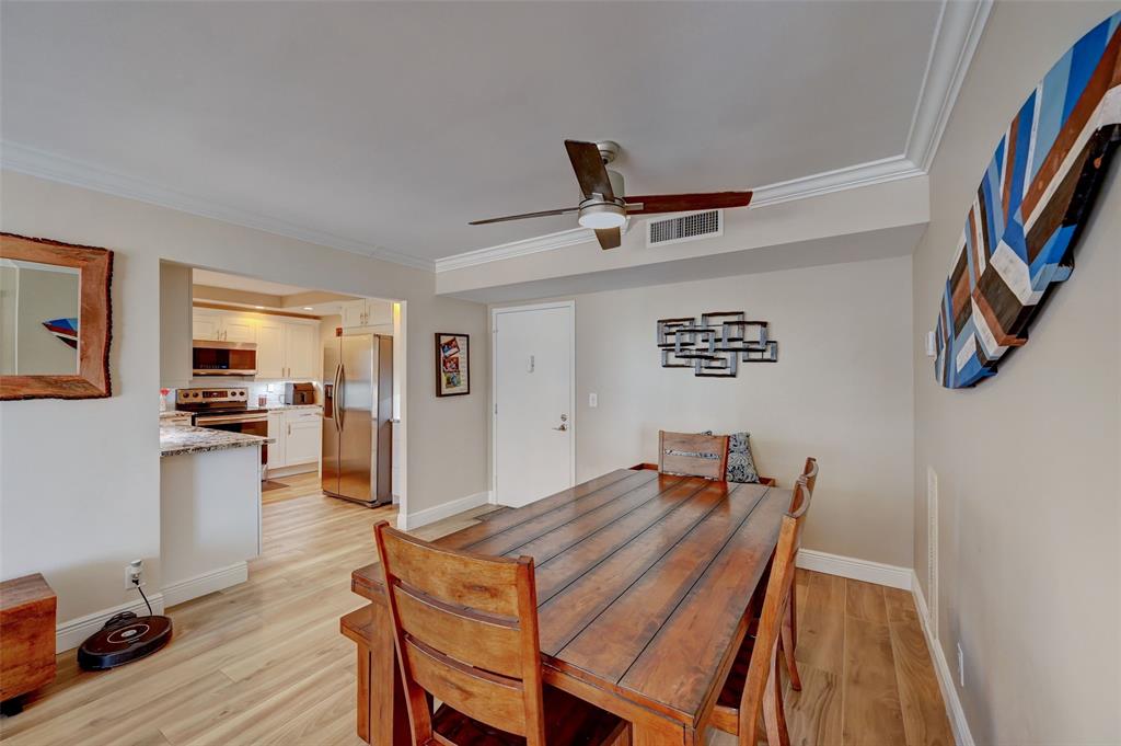531 North Ocean Boulevard, Unit 506 Pompano Beach, FL 33062 - Photo 9 of 47 a view of a dining room with furniture and wooden floor