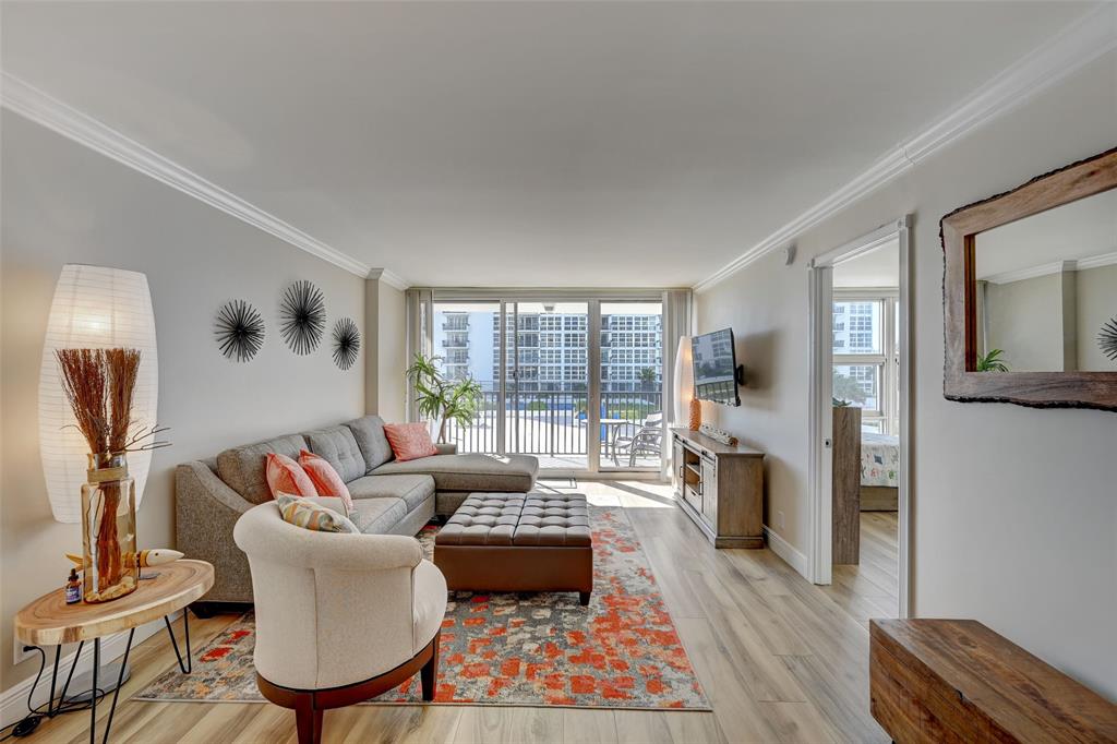 531 North Ocean Boulevard, Unit 506 Pompano Beach, FL 33062 - Photo 10 of 47 a living room with furniture and a large window