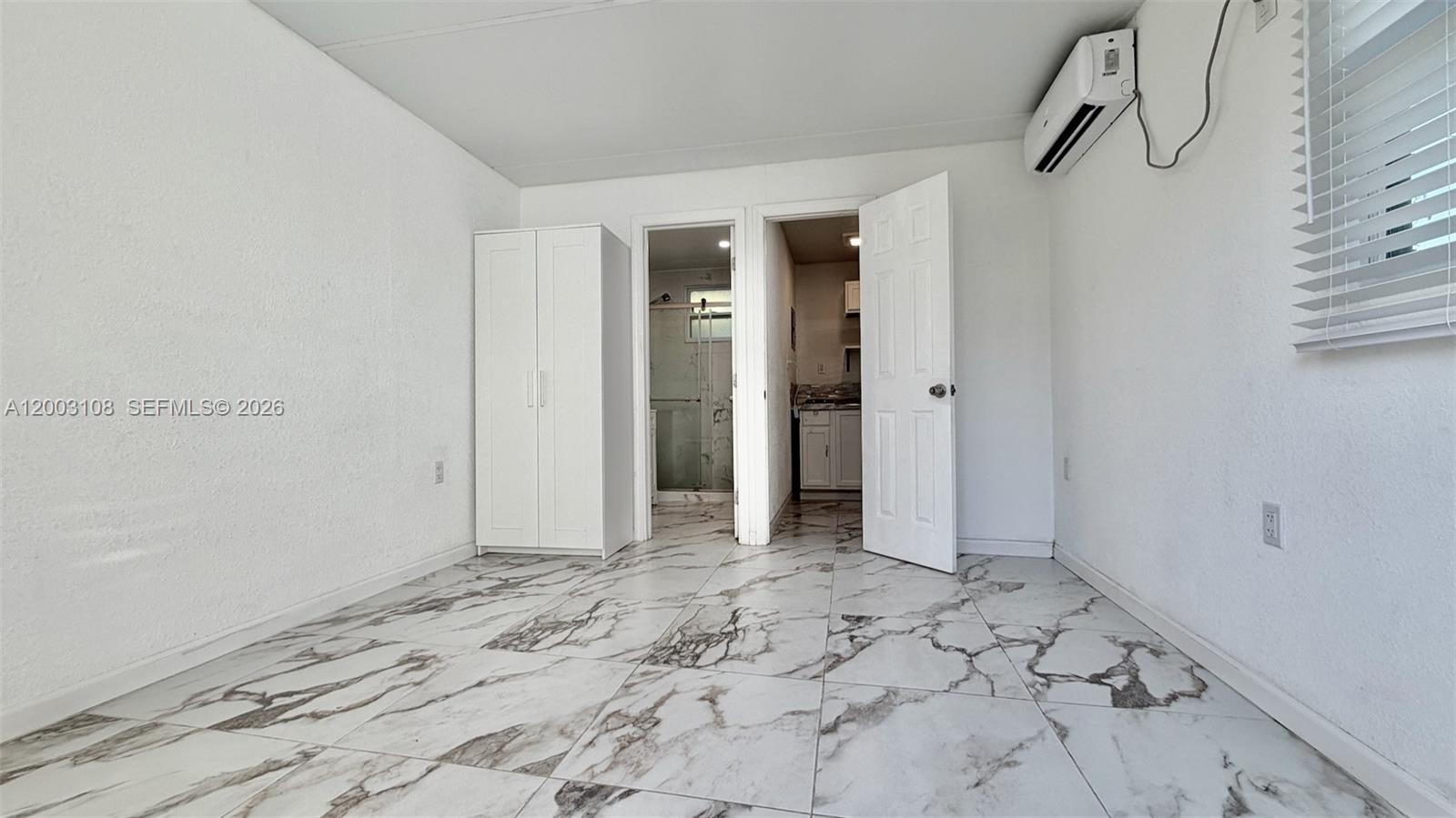 12435 Southwest 42nd Street, Unit 1 Miami, FL 33175 - Photo 3 of 7 a view of a bathroom with a sink and a mirror