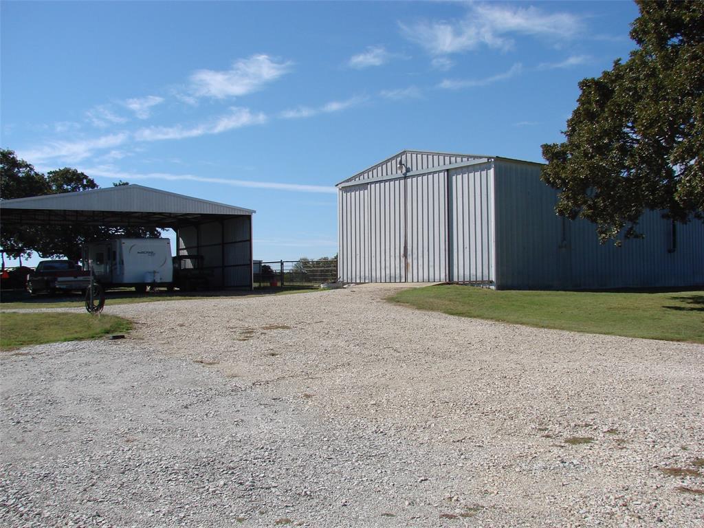 34 Denton Road Gordonville, TX 76245 - Photo 12 of 35 View of pole building featuring gravel driveway and a carport