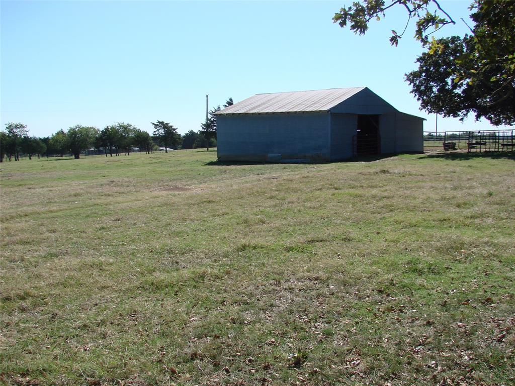 34 Denton Road Gordonville, TX 76245 - Photo 15 of 35 View of yard featuring an outbuilding, an outdoor structure, and a view of countryside