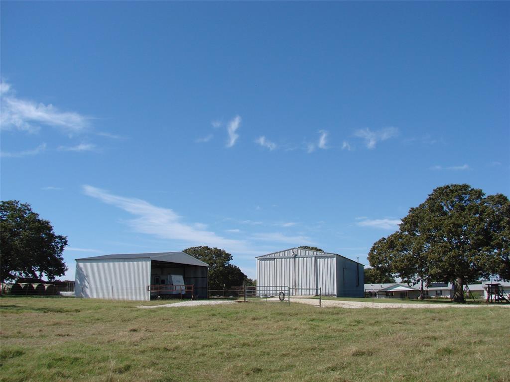 34 Denton Road Gordonville, TX 76245 - Photo 17 of 35 View of yard featuring an outbuilding and an outdoor structure