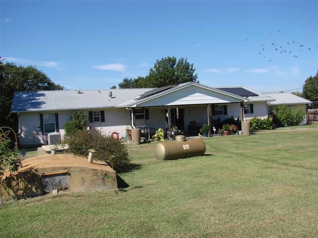 34 Denton Road Gordonville, TX 76245 - Photo 30 of 35 Back of property with a yard and a metal roof