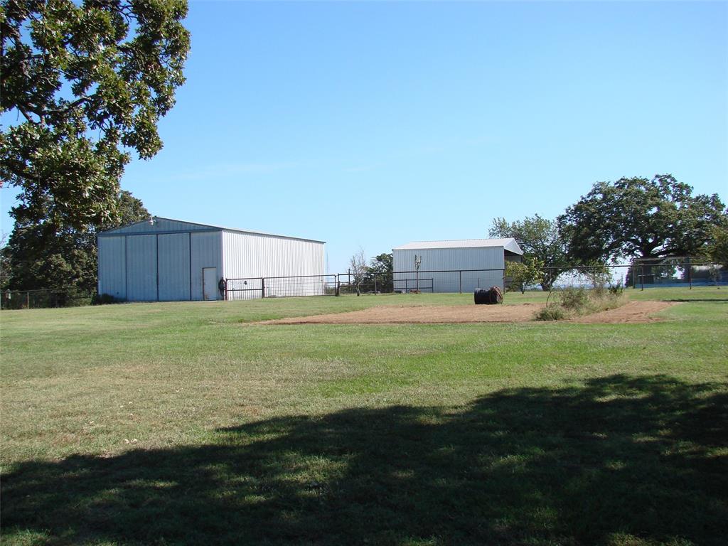 34 Denton Road Gordonville, TX 76245 - Photo 3 of 35 View of yard featuring an outbuilding and an outdoor structure