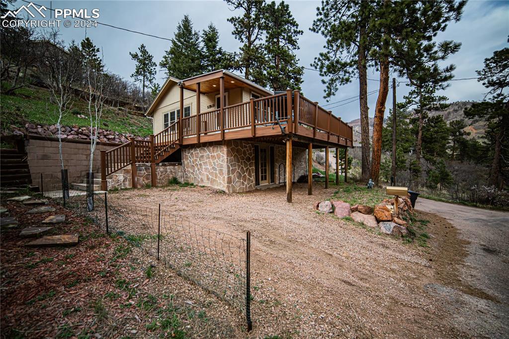 a view of a house with backyard and sitting area