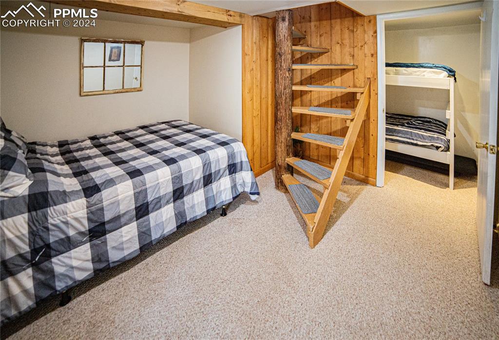 5870 Paona Road Cascade, CO 80809 - Photo 20 of 27 a bedroom with a bed and a walk in closet