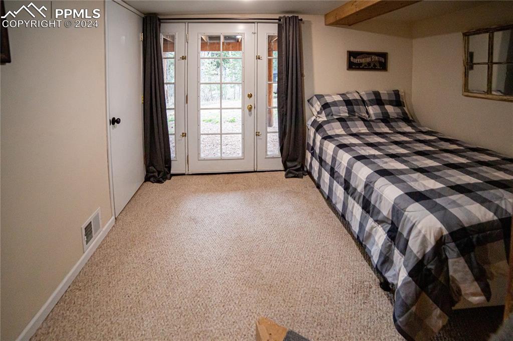 5870 Paona Road Cascade, CO 80809 - Photo 21 of 27 a bedroom with a bed and a window
