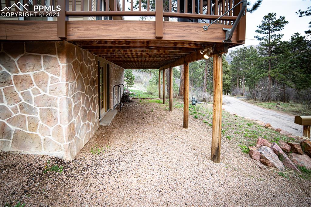 5870 Paona Road Cascade, CO 80809 - Photo 26 of 27 a view of a porch with a floor to ceiling window and tree