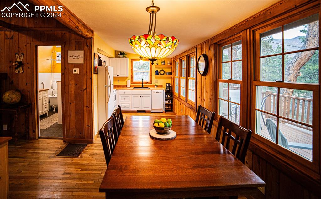 5870 Paona Road Cascade, CO 80809 - Photo 4 of 27 a view of a dining room with furniture a chandelier and wooden floor