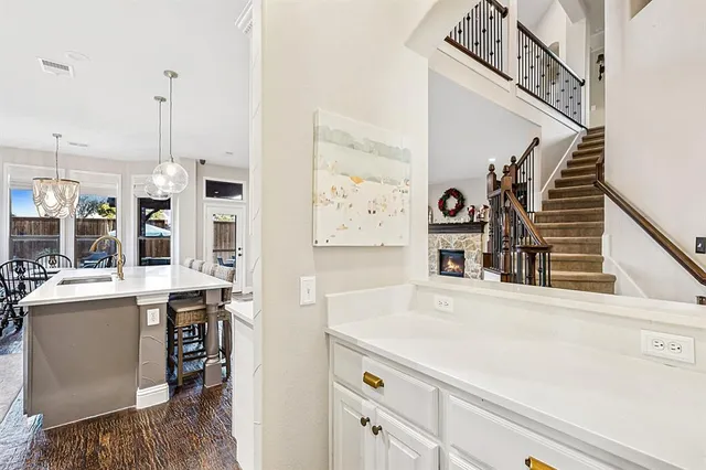 a view of a kitchen with furniture and wooden floor