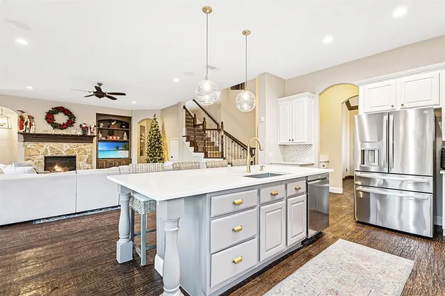 a kitchen with a sink stainless steel appliances and cabinets