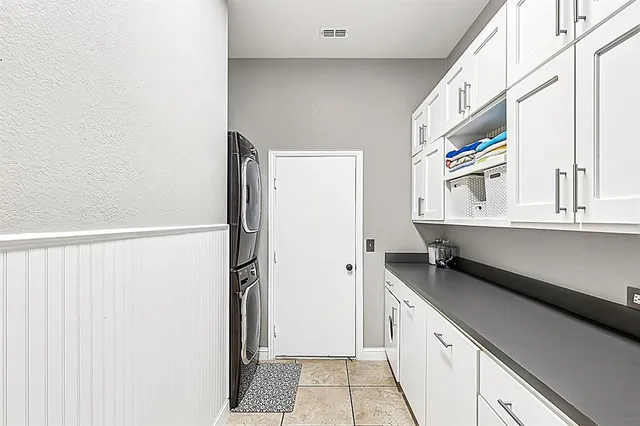 a kitchen with a refrigerator and a sink
