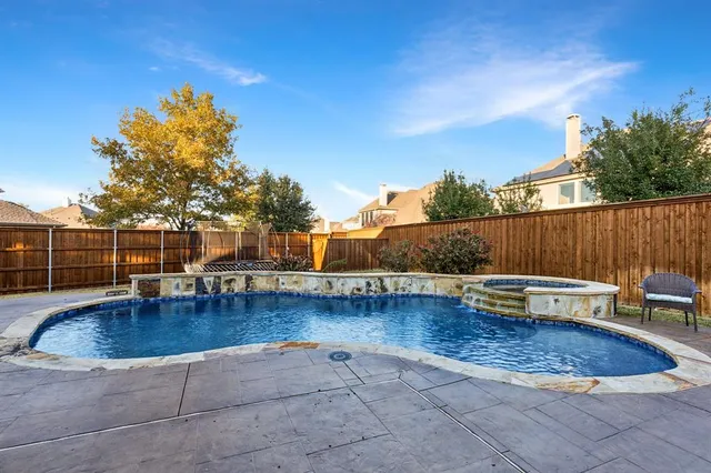 a view of a swimming pool with a lounge chair