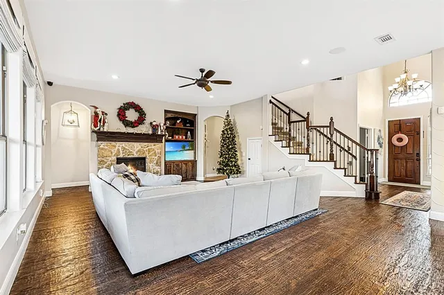 a living room with fireplace furniture and a flat screen tv