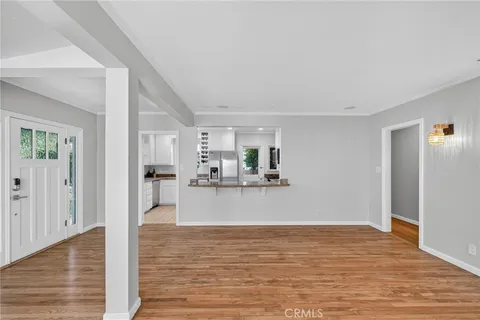a view of a living room kitchen and a wooden floor