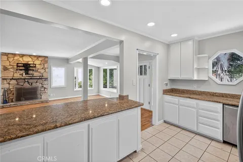 a kitchen with granite countertop a sink and a stove top oven