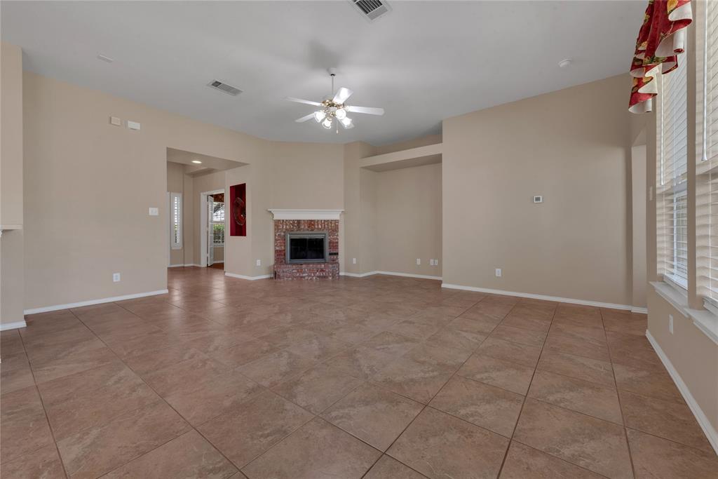 910 Derby Court Celina, TX 75009 - Photo 8 of 27 a view of empty room with fireplace and fan