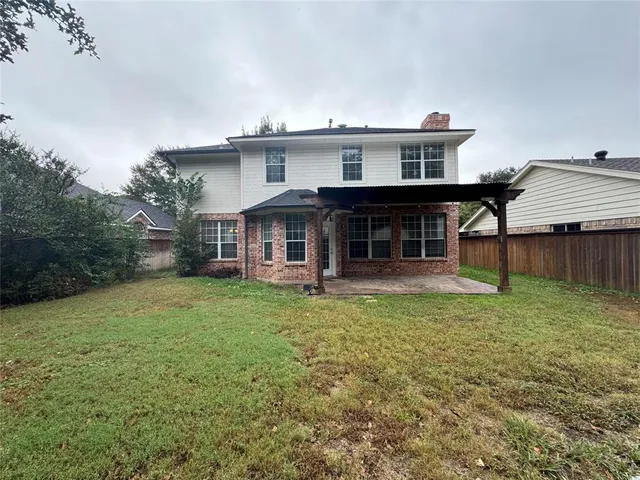 a view of a house with a backyard and balcony
