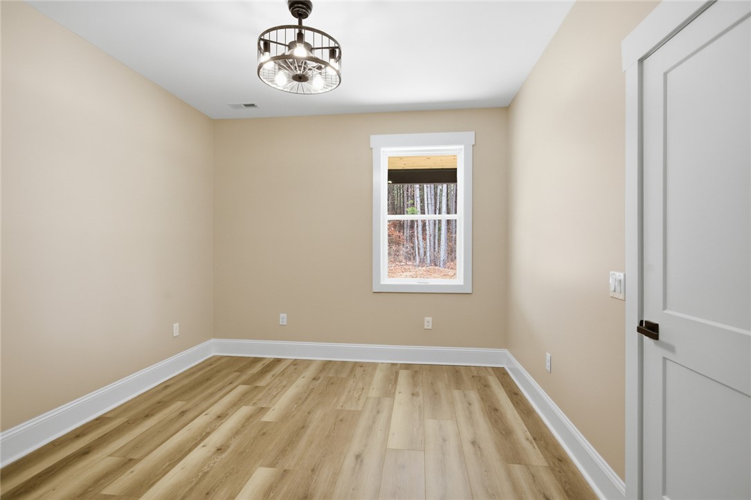 147 McAlister Road West Union, SC 29696 - Photo 20 of 49 This bright room features a window overlooking lush greenery, perfect for a home office or guest suite.