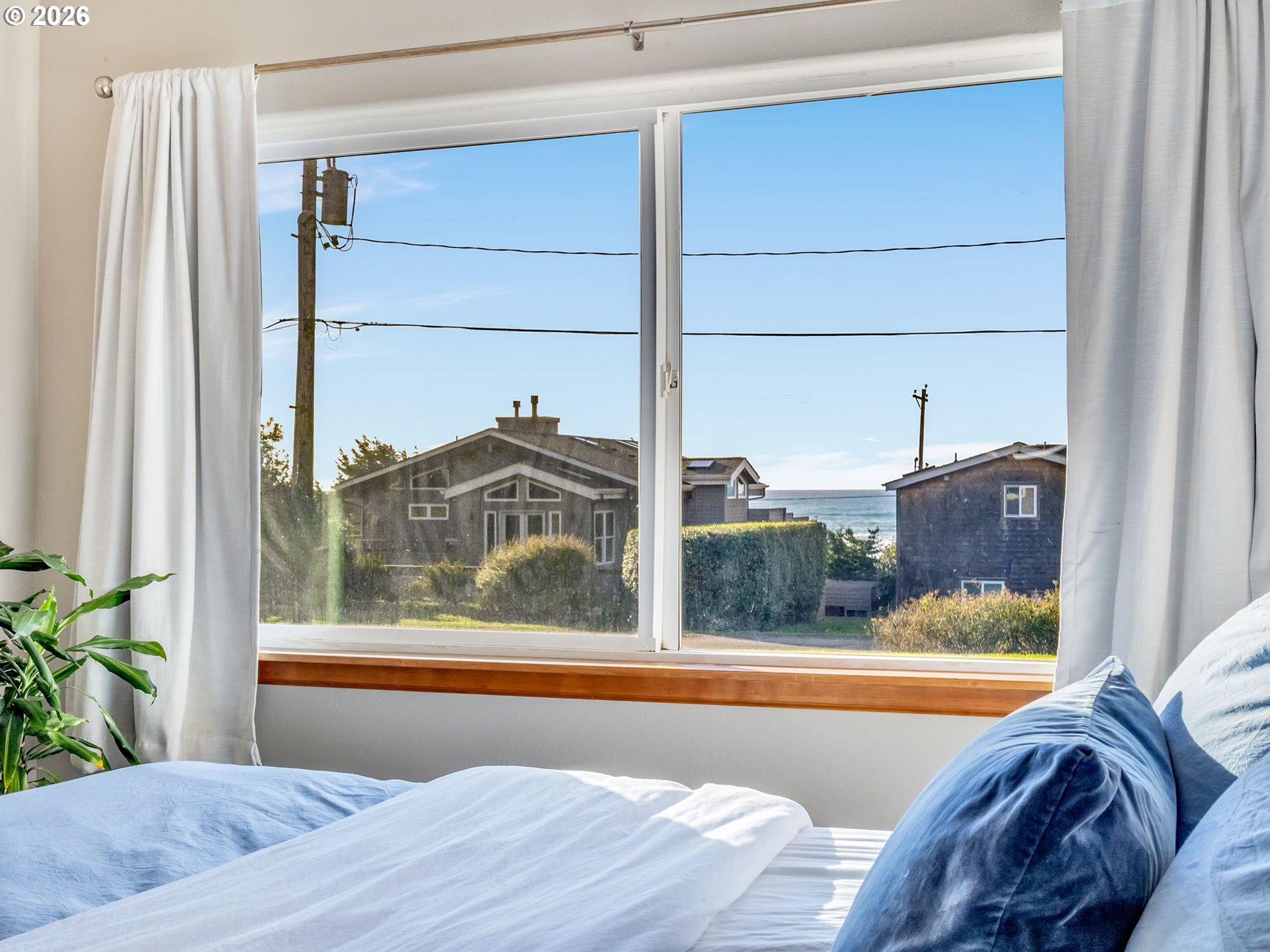37655 Treasure Hunters Lane Nehalem, OR 97131 - Photo 12 of 26 a view of a bedroom with a bed and wooden floor