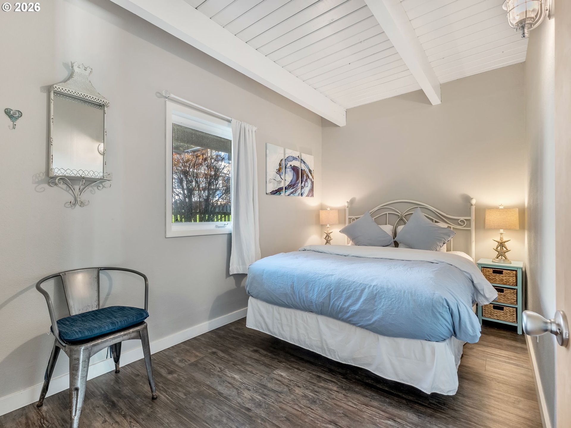 37655 Treasure Hunters Lane Nehalem, OR 97131 - Photo 18 of 26 a bedroom with a bed and wooden floor