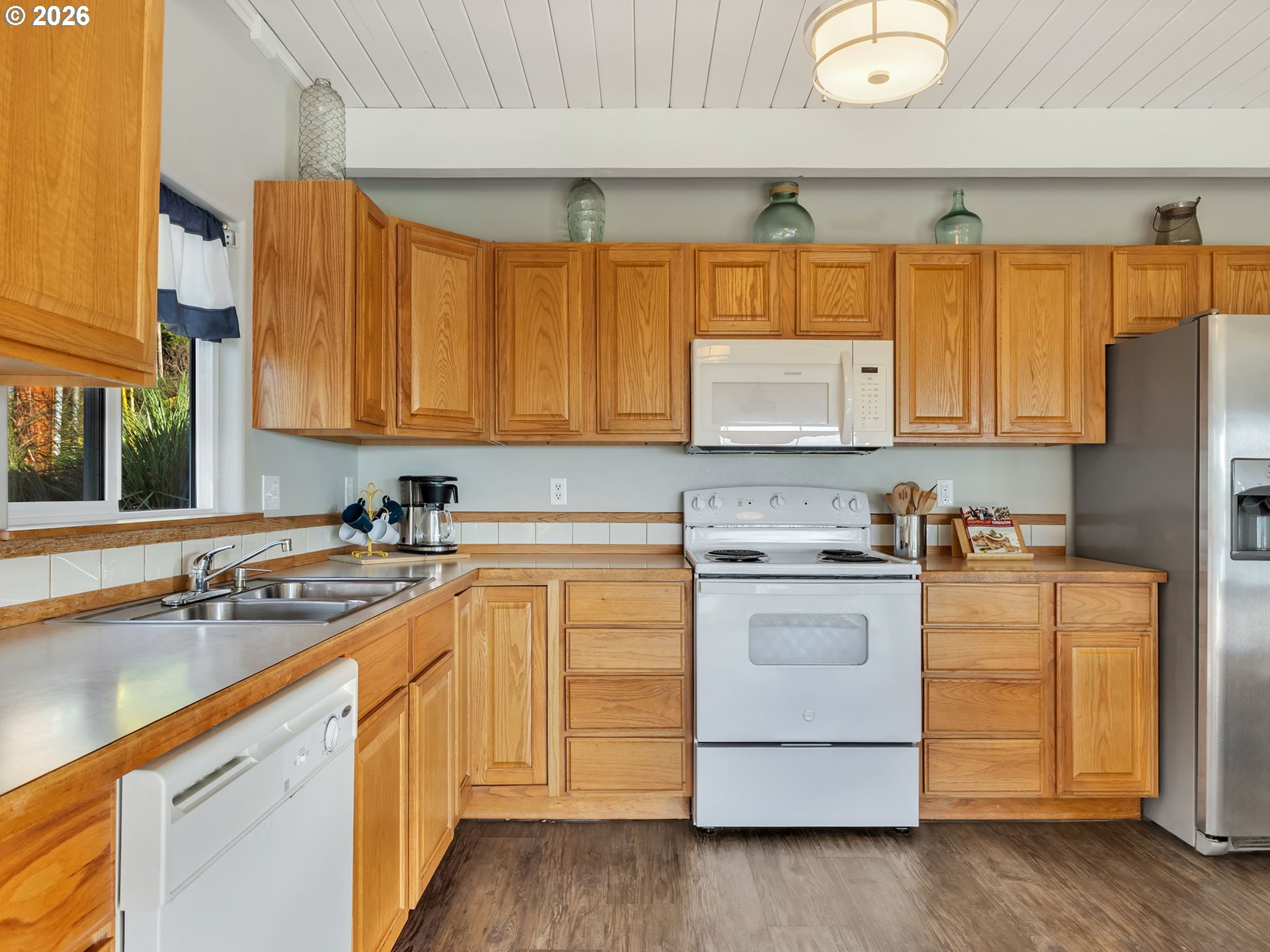37655 Treasure Hunters Lane Nehalem, OR 97131 - Photo 10 of 26 a kitchen with stainless steel appliances granite countertop a sink a stove and a refrigerator