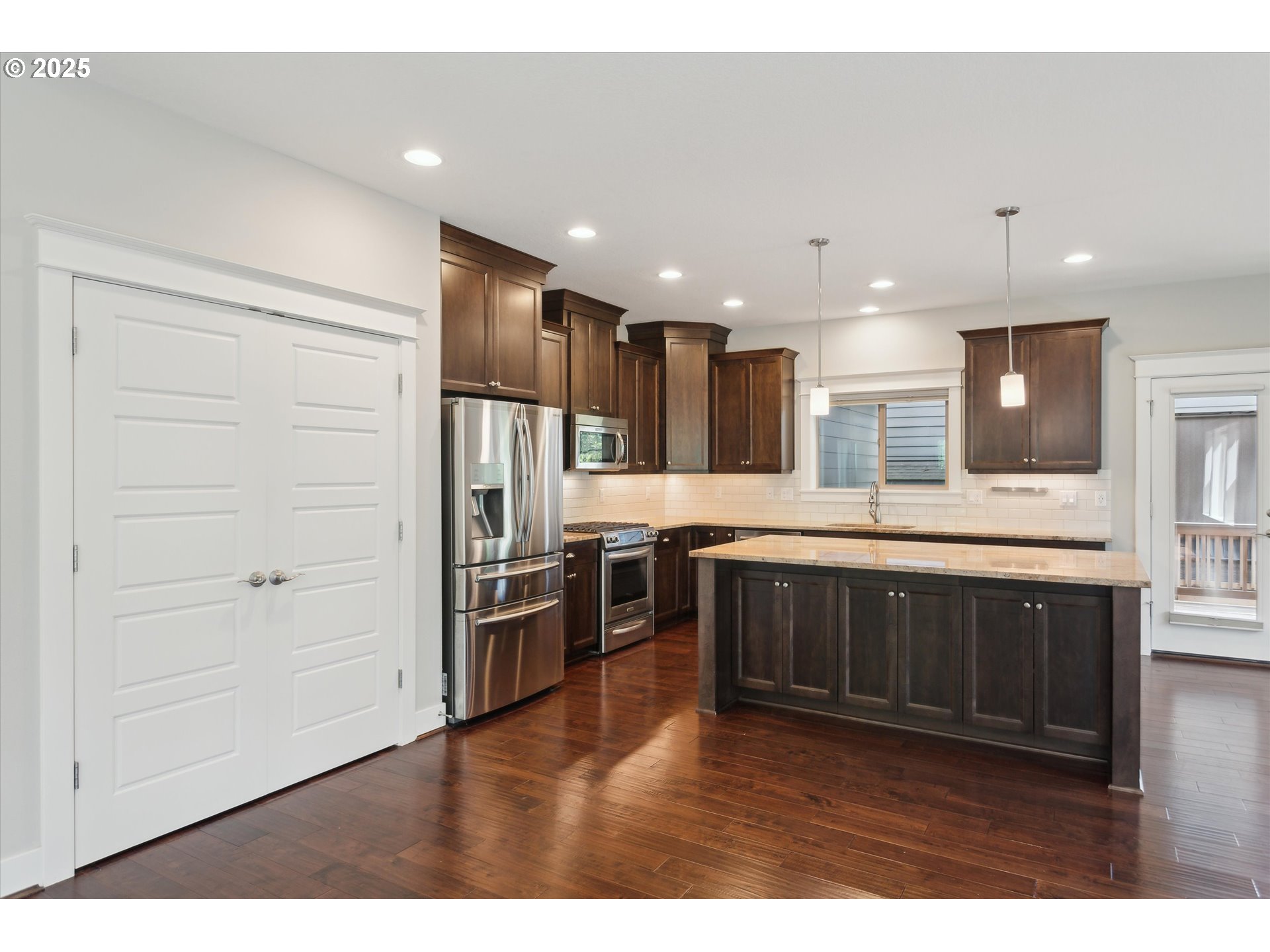 14320 Southwest Fox Lane Beaverton, OR 97008 - Photo 11 of 48 a kitchen with stainless steel appliances kitchen island granite countertop a refrigerator and a stove top oven
