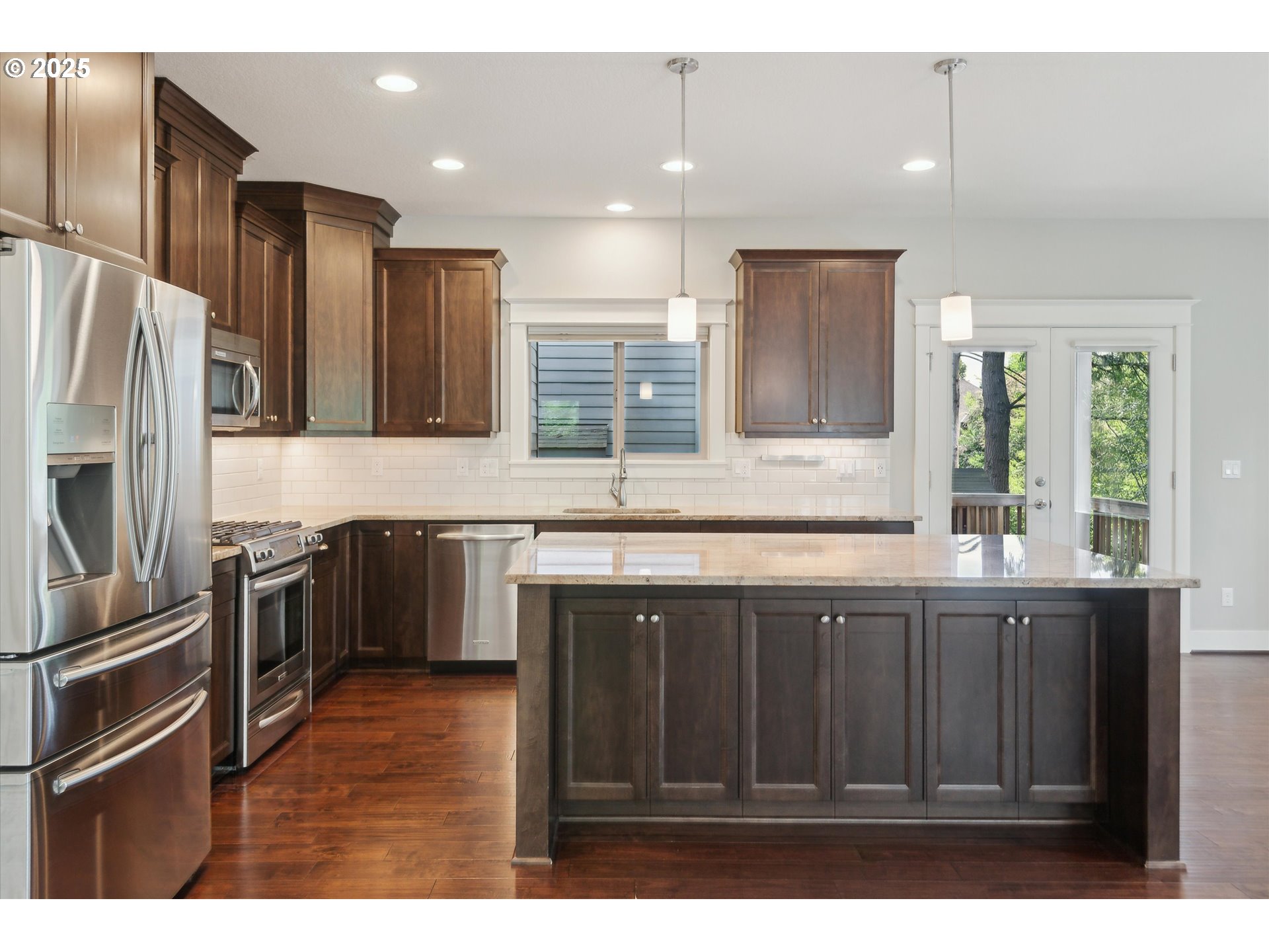 14320 Southwest Fox Lane Beaverton, OR 97008 - Photo 12 of 48 a kitchen with stainless steel appliances granite countertop a refrigerator and a sink