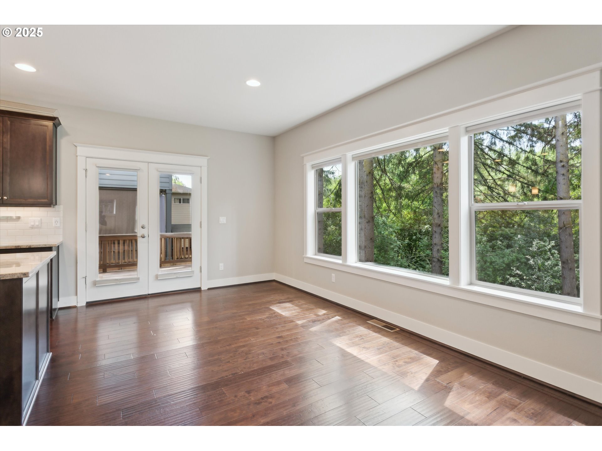 14320 Southwest Fox Lane Beaverton, OR 97008 - Photo 15 of 48 a view of an empty room with a window and wooden floor