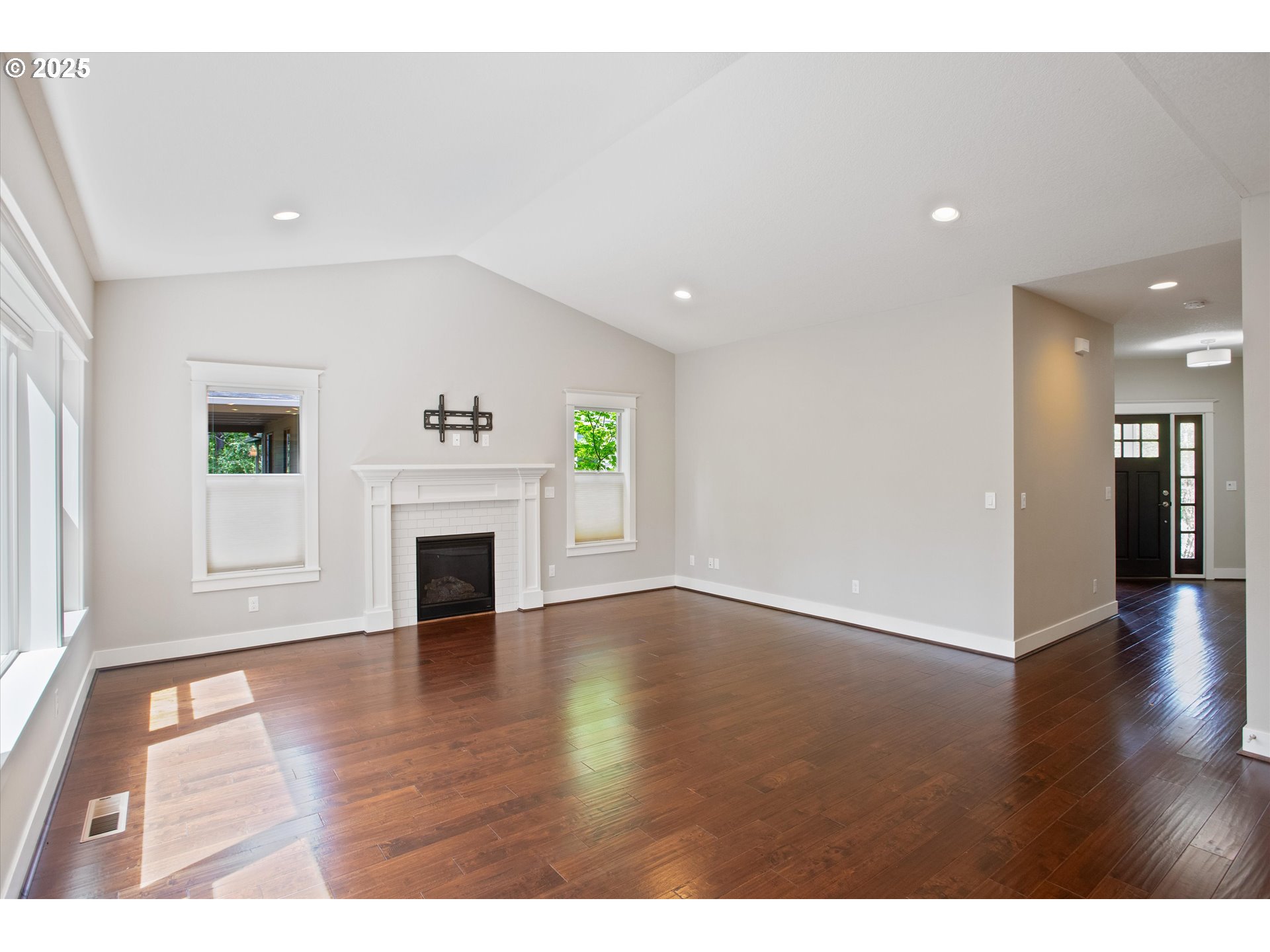14320 Southwest Fox Lane Beaverton, OR 97008 - Photo 9 of 48 a view of a livingroom with wooden floor and a fireplace