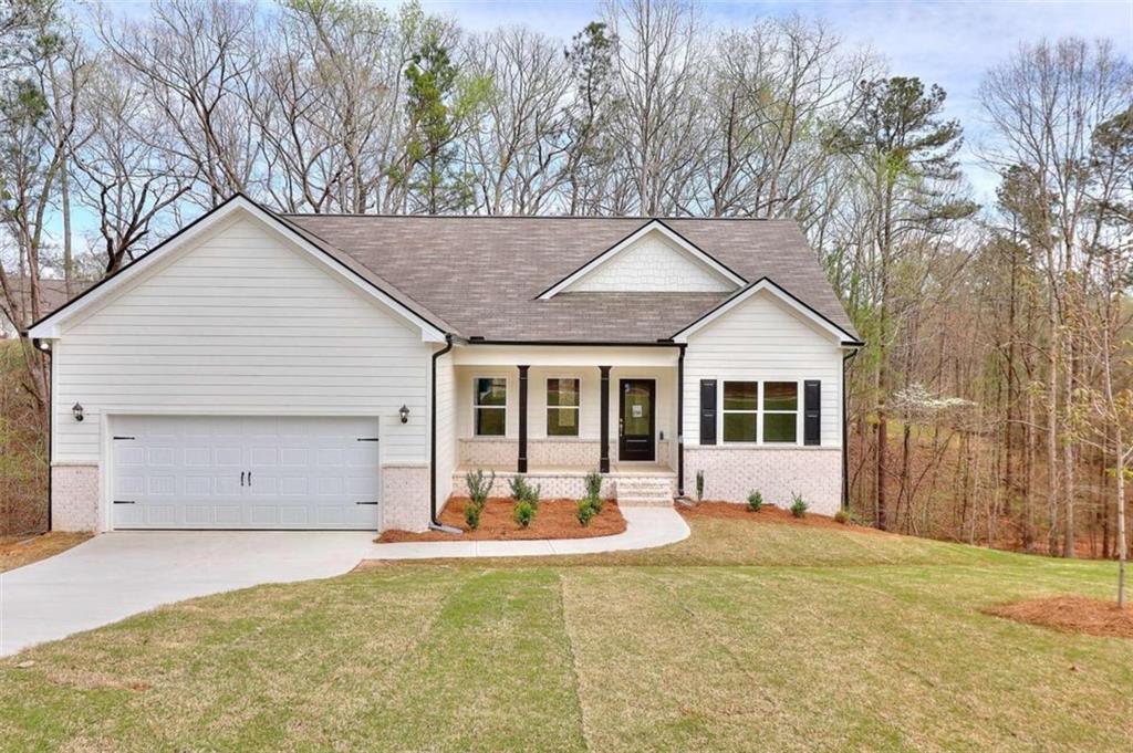 307 Tara Court Mansfield, GA 30055 - Photo 1 of 1 a front view of house with yard outdoor seating and garage