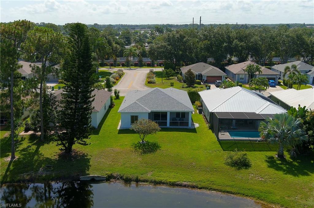 223 Stanhope Circle Naples, FL 34104 - Photo 35 of 41 Single-story residence with a light-toned hip roof
