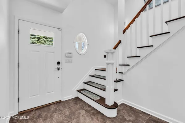 a view of entryway with stairs and wooden floor