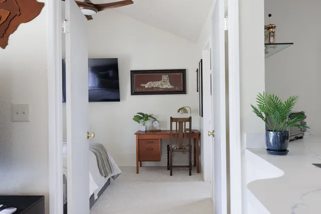 a workspace with furniture and a potted plant