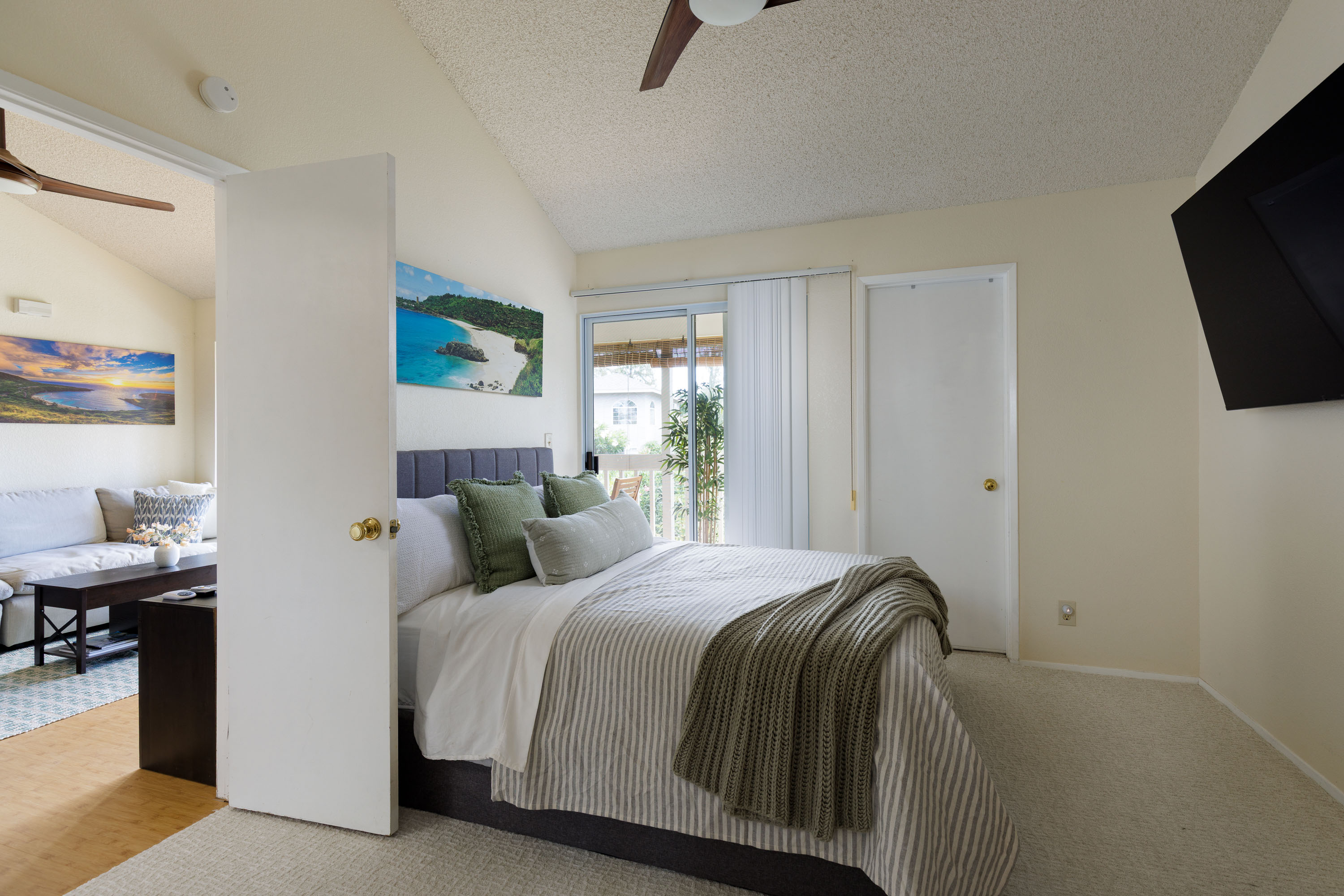 68-3890 Lua Kula Street, Unit 1408 Waikoloa, HI 96738 - Photo 13 of 22 a bedroom with a bed a flat screen tv and a window