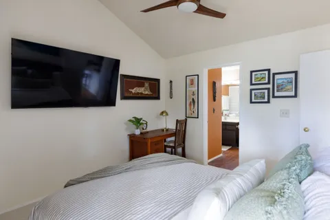 a bedroom with furniture and flat screen tv