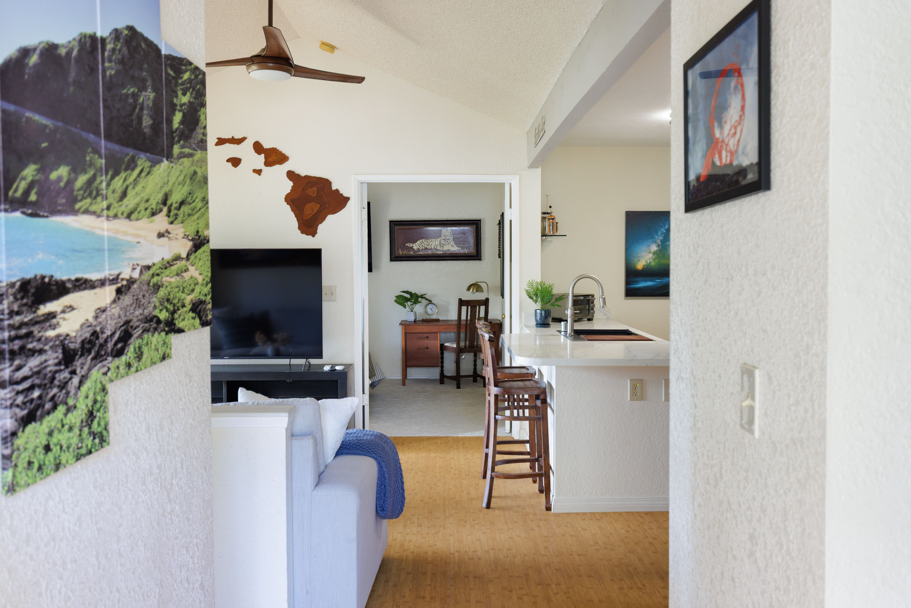 68-3890 Lua Kula Street, Unit 1408 Waikoloa, HI 96738 - Photo 3 of 22 a living room with furniture and a flat screen tv