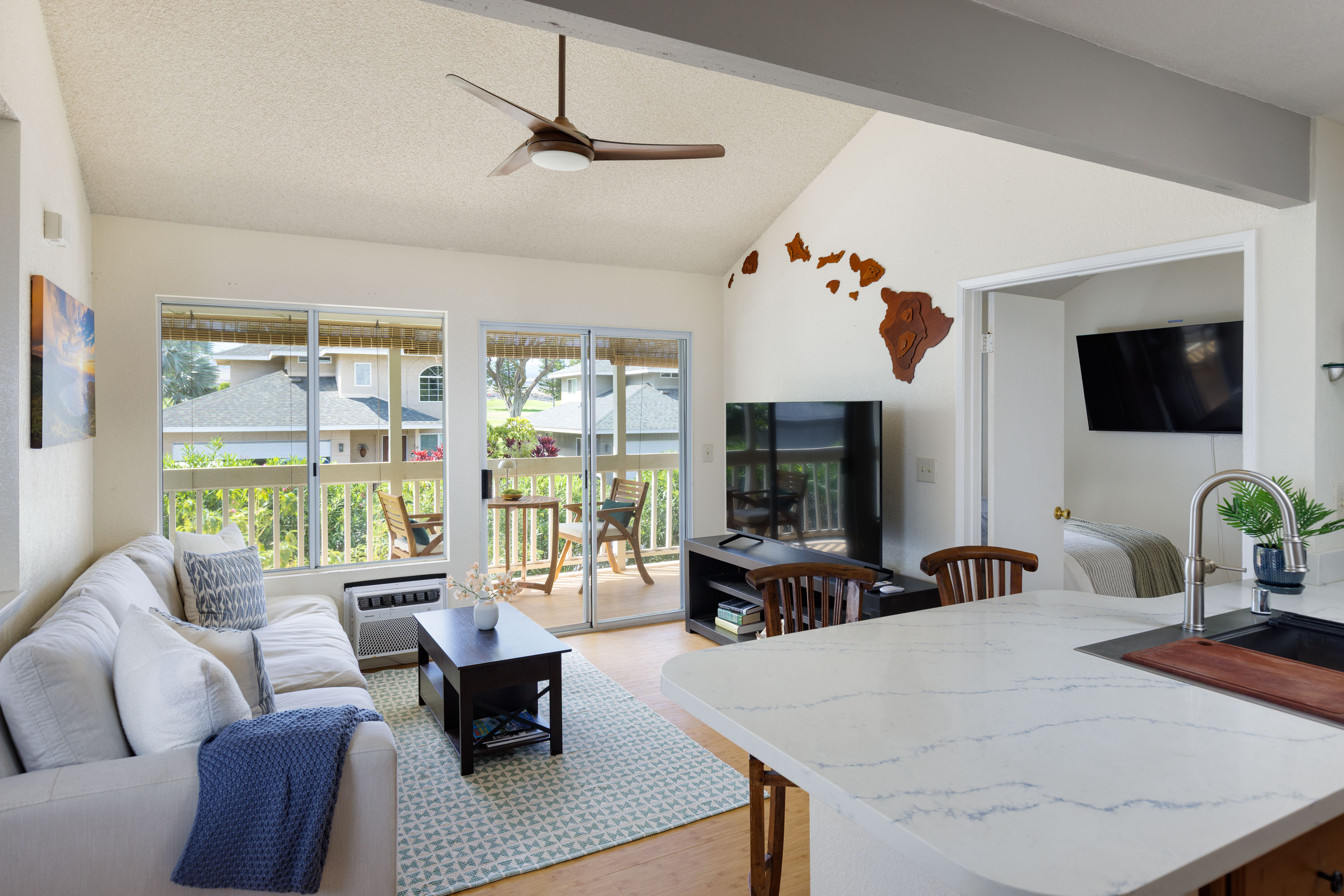 68-3890 Lua Kula Street, Unit 1408 Waikoloa, HI 96738 - Photo 4 of 22 a living room with furniture a flat screen tv and a large window