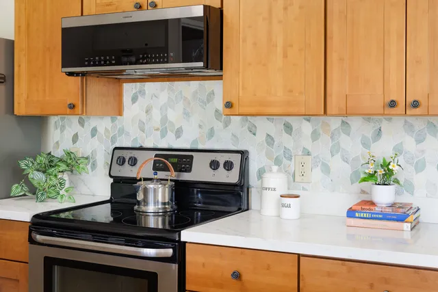 a kitchen with stainless steel appliances granite countertop a stove and a microwave