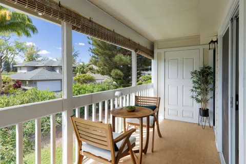 a view of a chair and table in the balcony