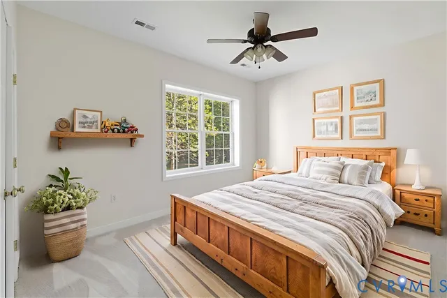 a bedroom with a bed and a potted plant