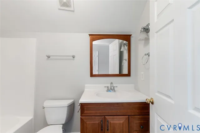 a view of a room with a ceiling fan and window