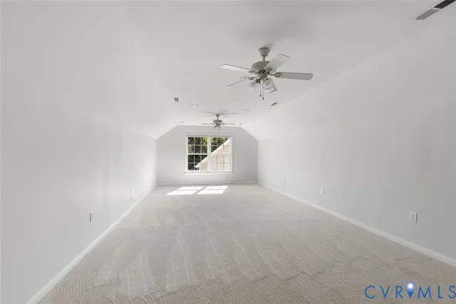 a view of a hallway with toilet and a bathroom