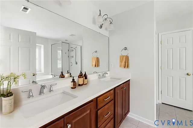a bathroom with a double vanity sink and a mirror